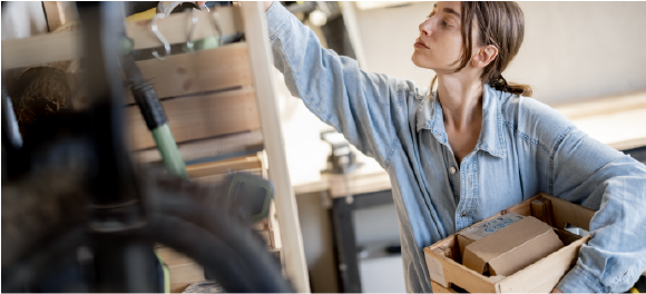 woman putting items away on garage shelves