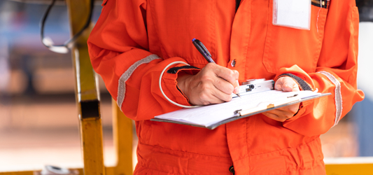 construction worker signing a document