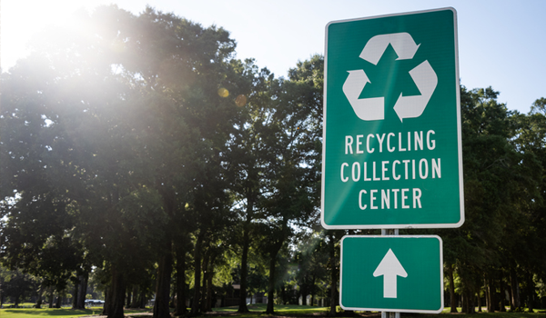 sign point to recycling collection center