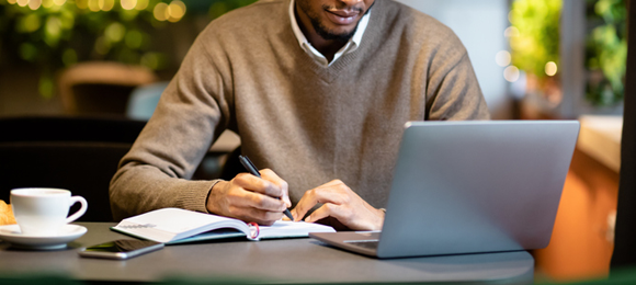 man looking at his laptop