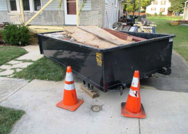 dumpster partially blocking sidewalk